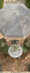 Banner décoratif Parasol rayé bleu - Parasol rayé gris et blanc avec fauteuils en rotin vert olive, gypsophile et bougies, ambiance jardin élégant