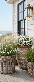 Banner décoratif Pavillon blanc - Pavillon blanc en bardeaux avec fenêtre noire, marguerites blanches et herbes de pampa, vue sur mer